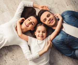 happy girl and parents pose for picture